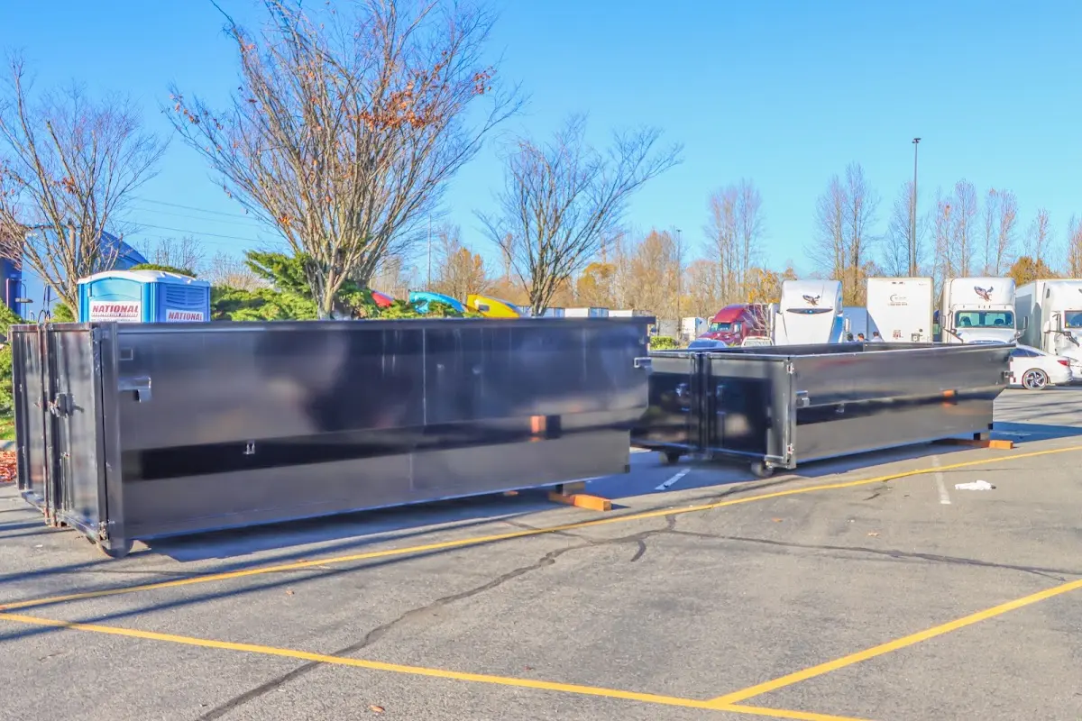 Professional dumpster rental service with roll-off container on residential driveway in Cortlandville